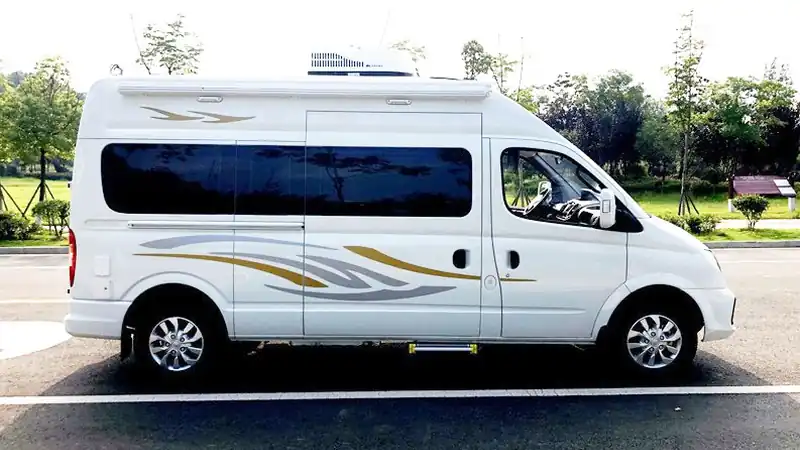 Side view of a white Maxus high-roof van converted into a campervan