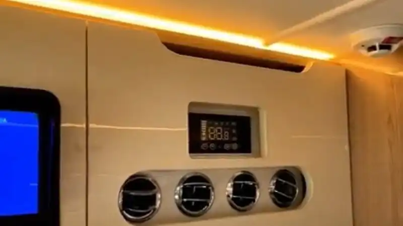 Motorhome electrical control panel with switches and displays above the entry door