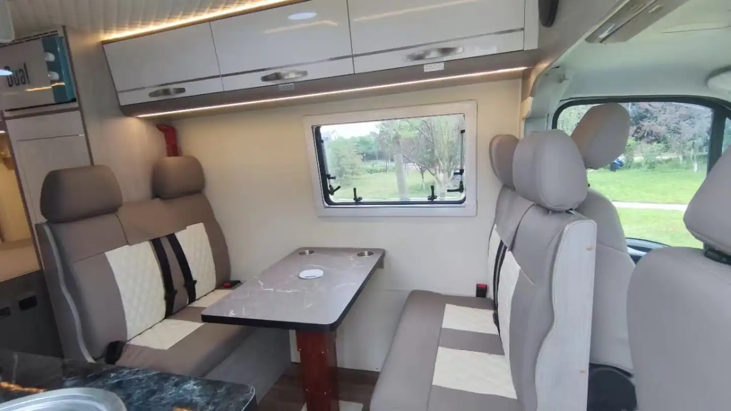Campervan dinette with swivel seats and a table, ready for working on the road